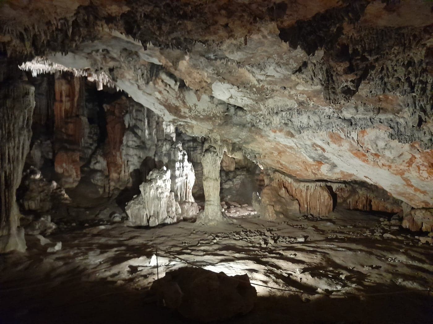 The chamber of Grapčeva Cave near Humac — stalactites in warm stone light