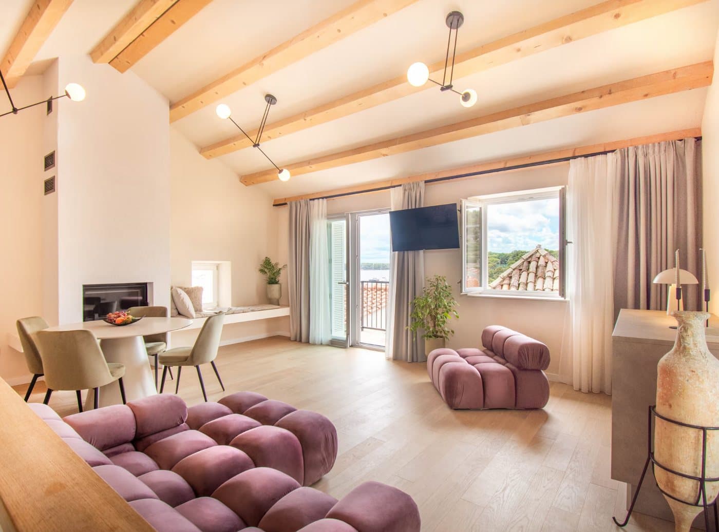 Open-plan living room with lavender sofa and sea view — Heritage House Kaleta, Hvar old town