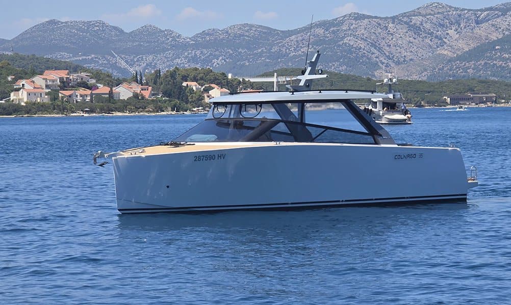 The Colnago 35 at anchor off the coast — Antonija's flagship, teak foredeck and 480 hp