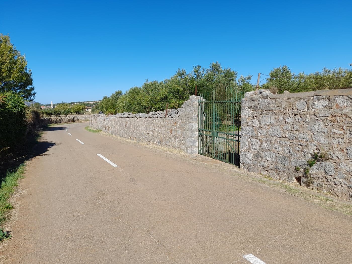 A road through the Stari Grad Plain — drystone walls, olives and the Greek field pattern