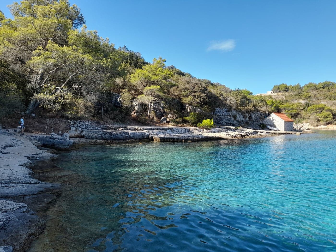 Žukova bay — stepped limestone, a stone house under the pines and clear water